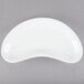 A Tuxton white porcelain crescent dish with a curved edge.