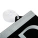 A Headline Sign Century Series black and white reversible sign with a suction cup attached to a black and silver frame.
