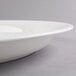 A white plastic oval Fineline Cater Tray with a rim.