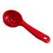 A red Carlisle plastic portion spoon with a hole in the middle.