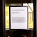 A DURAFRAME black sign holder on a glass door.