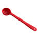 A red plastic Carlisle long handle perforated portion spoon.