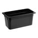 A Carlisle black plastic food pan on a counter.