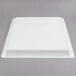 A white square Fineline plastic catering tray with a lid on top.