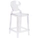 A clear plastic counter height stool with a clear tear back.