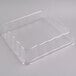 A clear plastic container with a clear plastic square dome lid.