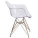 A Flash Furniture Alonza clear plastic side chair with a gold base.