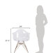 A woman standing next to a Flash Furniture clear polycarbonate side chair with a gold frame.