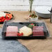 A Fineline clear plastic rectangular dome lid on a tray of vegetables and dip.