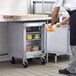 A man in a kitchen with a Beverage-Air undercounter refrigerator.