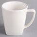 A Hall China bright white mug with a handle.