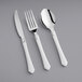 A Visions plastic silverware set with white handles including a fork, knife, and spoon.