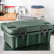 A granite green Cambro Ultra Pan Carrier on a counter.