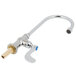 A silver faucet with a blue wrist handle.