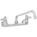 A chrome Equip by T&S wall mount faucet with two lever handles.