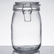 A 4 pack of clear glass Choice hinge top storage jars with metal lids.