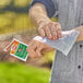 A person using an OFF! Deep Woods insect repellent towelette to wipe their wrist.