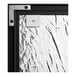 A close up of a metal corner on a Quartet cork board with a black aluminum frame.