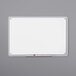 A white Quartet Total Erase whiteboard with a clear plastic frame and a red marker.
