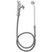 A T&S bedpan washer faucet with a hose and extended spray nozzle.