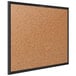 A Quartet cork board with a black frame.