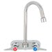 A chrome T&S wall mount faucet with lever handles.