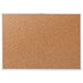 A Quartet cork board with a silver aluminum frame.