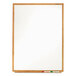 A Quartet melamine whiteboard with an oak finish frame.
