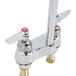 A T&amp;S chrome deck-mounted faucet with lever handles.