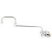 A silver T&S wall mounted faucet with lever handles and a double-jointed swing spout.