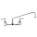 A T&S chrome wall mount faucet with lever handles and a 12" swing spout.