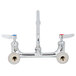 A T&S chrome wall mount faucet with two lever handles.