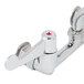 A white Equip by T&S wall mount faucet with chrome and red accents.