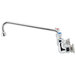 A silver T&S wall mount faucet with a long spout and lever handles.