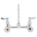 A T&S chrome wall mount faucet with two lever handles.
