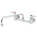 A T&S chrome wall mount faucet with two lever handles.