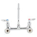 A T&S chrome wall mount faucet with two lever handles.