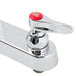 A T&S chrome deck-mounted faucet with lever handles and a red button on the side.