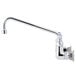 A close-up of a T&S chrome wall mount faucet with lever handles.