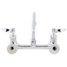A chrome T&S wall mount faucet with lever handles.