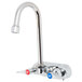 A chrome T&S wall mount faucet with lever handles.