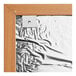 A white rectangular cork board with an oak frame.