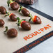 Chocolate covered strawberries on a Sasa Demarle Roul'pat baking sheet.