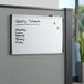 A Quartet magnetic steel whiteboard with black writing on it.