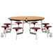 A National Public Seating round cafeteria table with a metal base and seats on wheels.