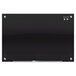 A Quartet black glass magnetic markerboard with silver screws.