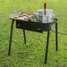 A Backyard Pro steamer pot on a grill full of food.