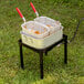 A Backyard Pro dual basket fryer on a table outdoors.