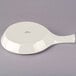 A white round Tuxton China fry pan server with a handle.