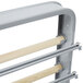 A metal rack with wooden bars for paper rolls.